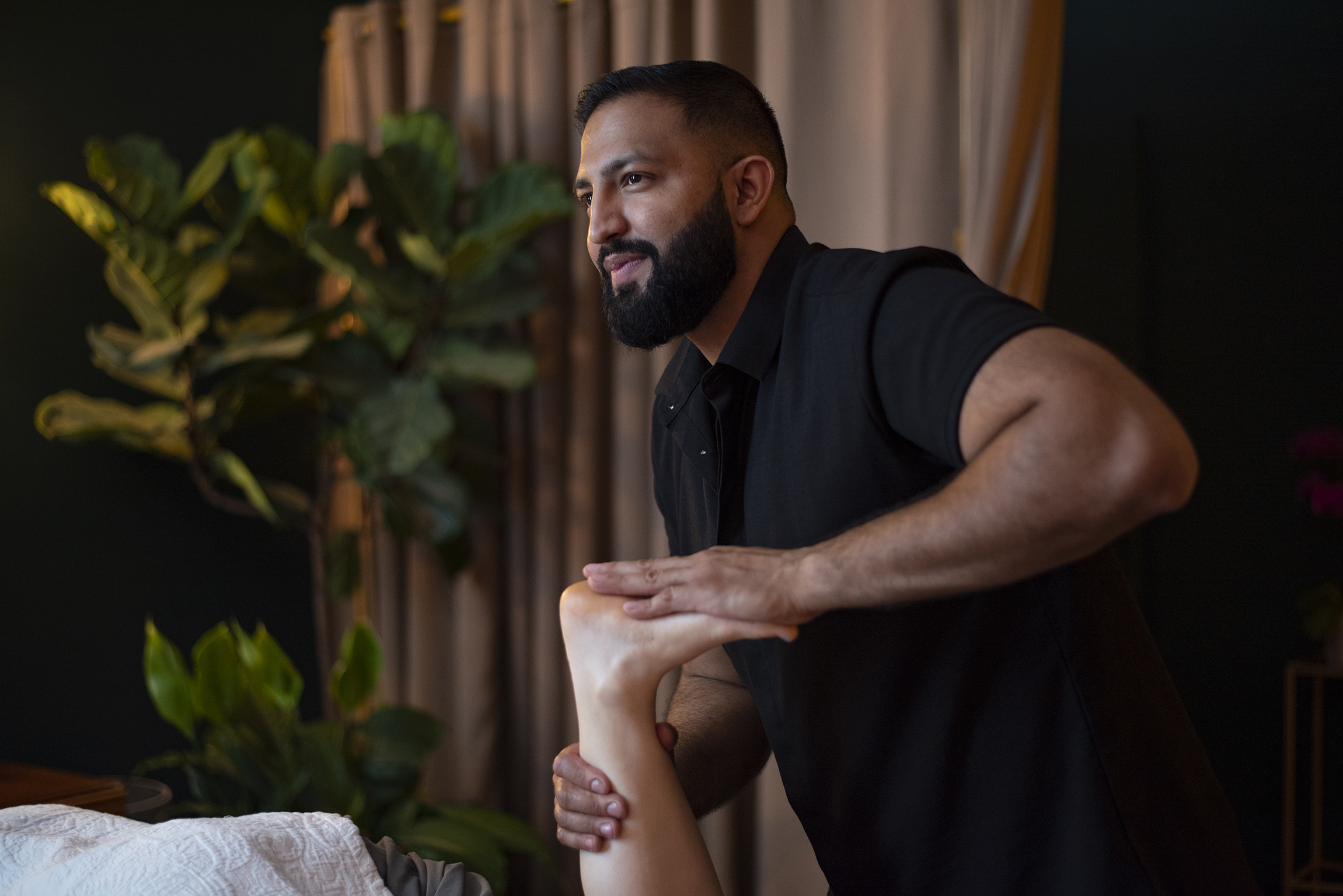 Arash Bains performing Deep Restorative Massage in his downtown Asheville studio